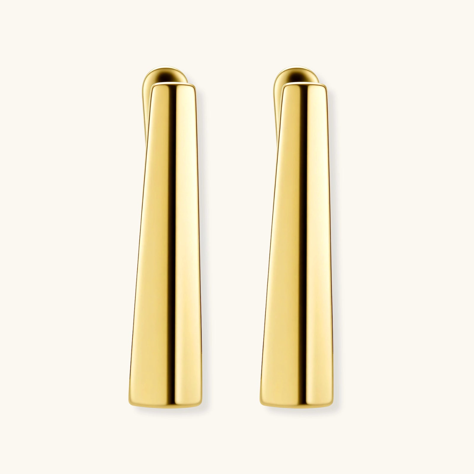 Sleek 14K gold-plated sterling silver huggie earrings with polished finish and geometric elongated design on white background.