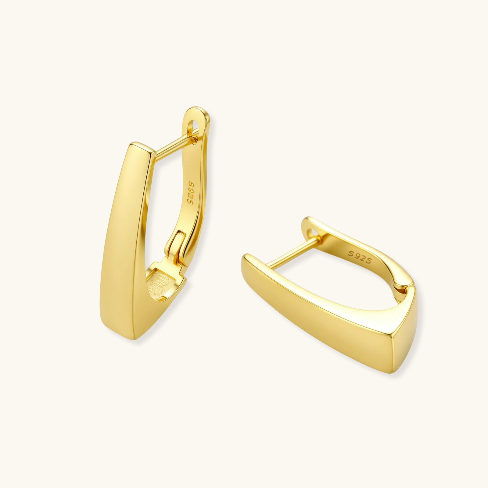 Sleek 14K gold-plated sterling silver huggie earrings with polished finish and geometric elongated design on white background.